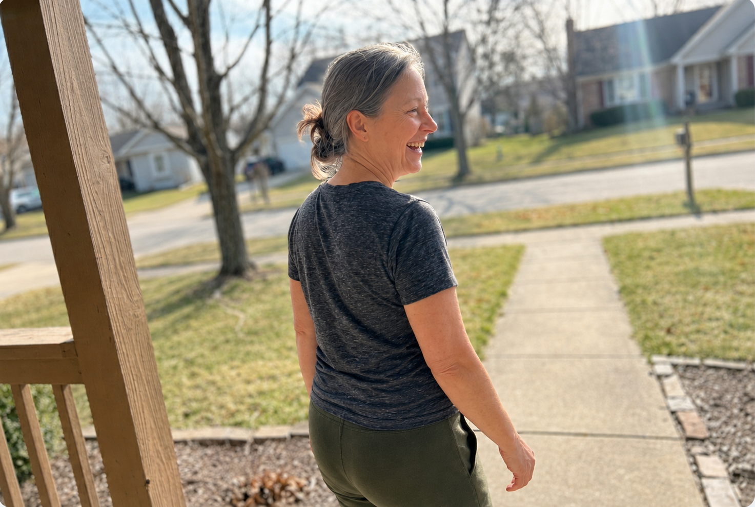 Sarah walking outside on a sunny day, relaxed and laughing